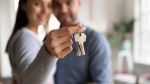 Close up happy woman hugging man, holding keys from new house, concept for How Does Cohabitation Affect Spousal Maintenance in Minnesota?